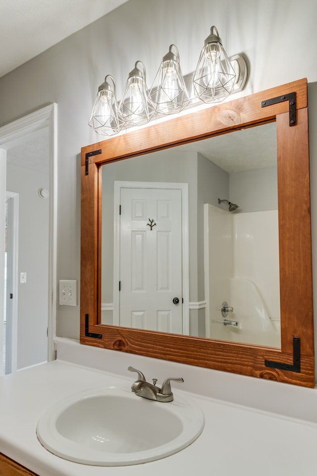 bathroom featuring vanity and washtub / shower combination