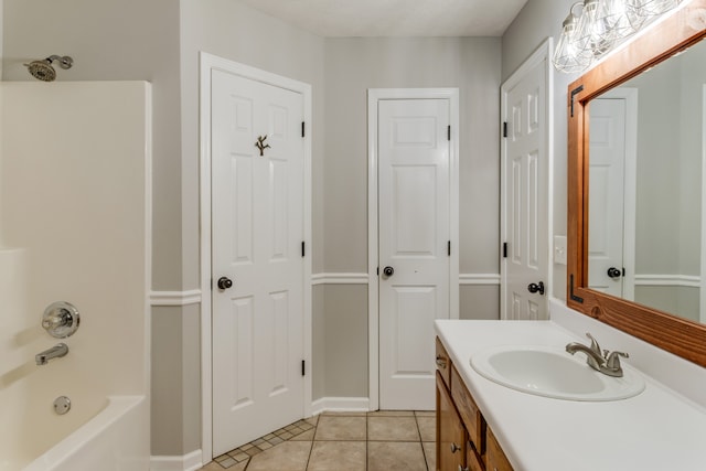 bathroom with tile patterned floors, vanity, and washtub / shower combination