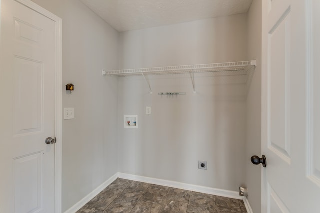 washroom featuring hookup for a washing machine, a textured ceiling, and electric dryer hookup