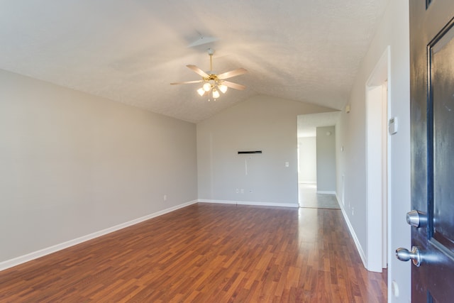 unfurnished room with a textured ceiling, ceiling fan, dark hardwood / wood-style flooring, and vaulted ceiling