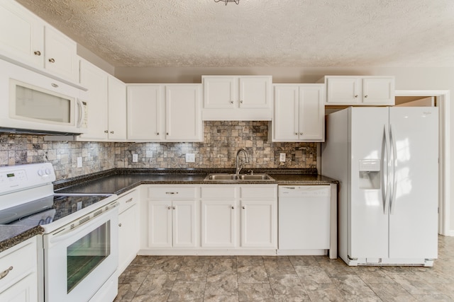 kitchen featuring sink, white cabinets, and white appliances