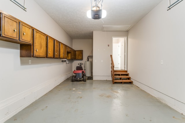 garage with gas water heater and a garage door opener