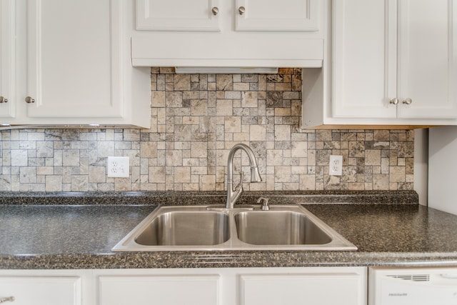 kitchen with tasteful backsplash, white cabinetry, white dishwasher, and sink