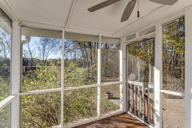 unfurnished sunroom featuring ceiling fan