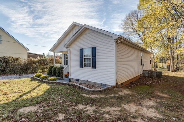 view of side of property with a porch and a yard