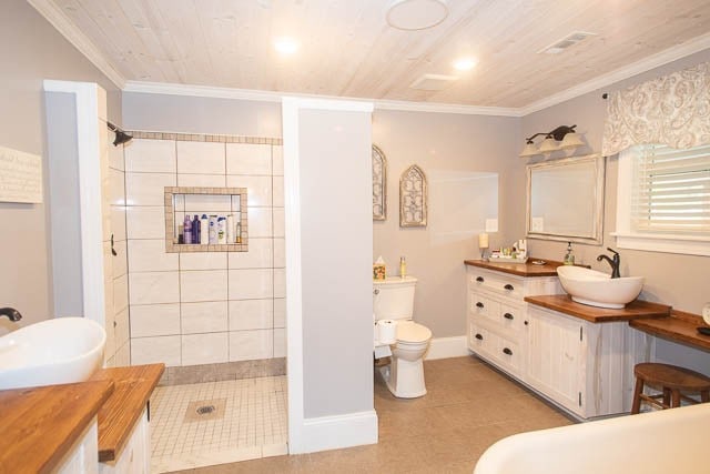 bathroom with vanity, wooden ceiling, crown molding, toilet, and walk in shower