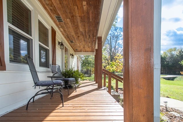 wooden terrace with a porch