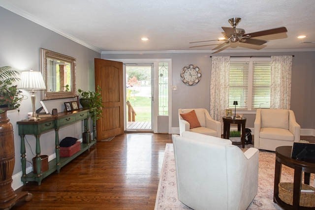 living room with ceiling fan, hardwood / wood-style floors, and ornamental molding