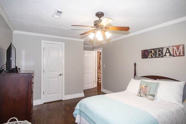 bedroom featuring ceiling fan, dark hardwood / wood-style flooring, and ornamental molding