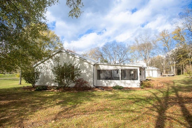 view of property exterior featuring a lawn