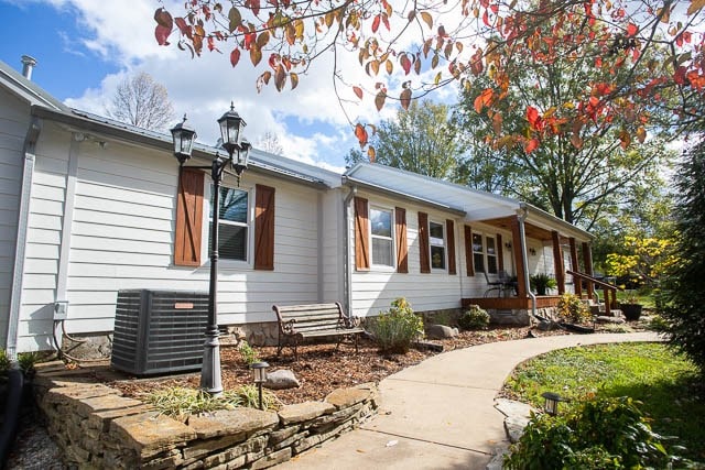 view of front of house with a porch and central AC