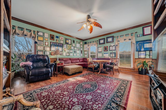 living area featuring crown molding, ceiling fan, and hardwood / wood-style flooring