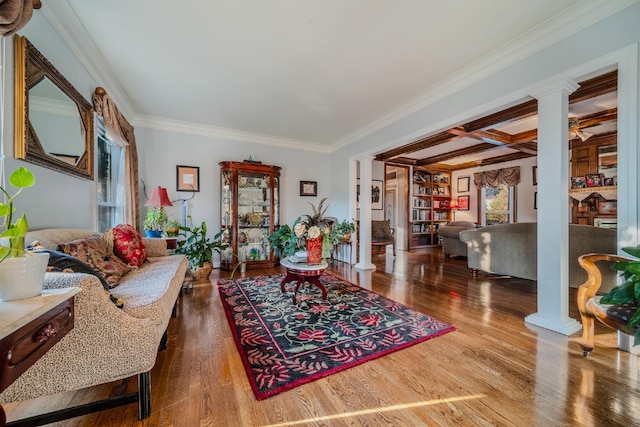 living room featuring ornate columns, coffered ceiling, crown molding, wood-type flooring, and beamed ceiling