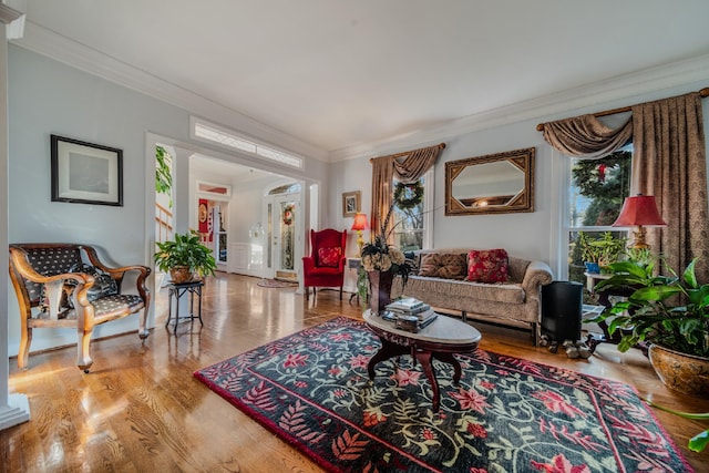 living room with light wood-type flooring and ornamental molding