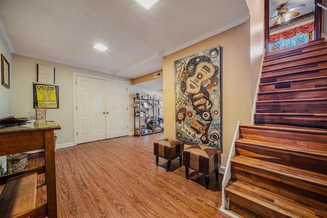 entrance foyer featuring ceiling fan, light hardwood / wood-style floors, and ornamental molding