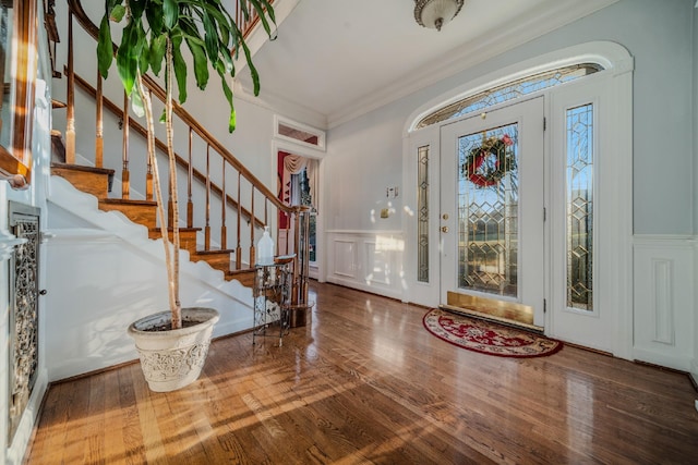 foyer entrance featuring wood-type flooring and ornamental molding