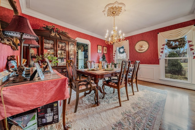 dining area featuring a chandelier, crown molding, and wood-type flooring