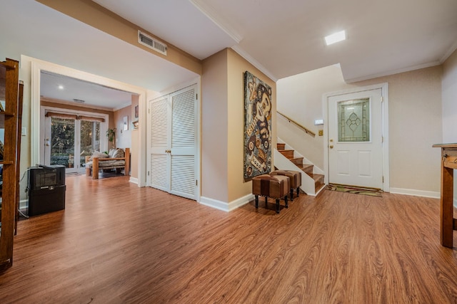 entrance foyer featuring light hardwood / wood-style floors and ornamental molding