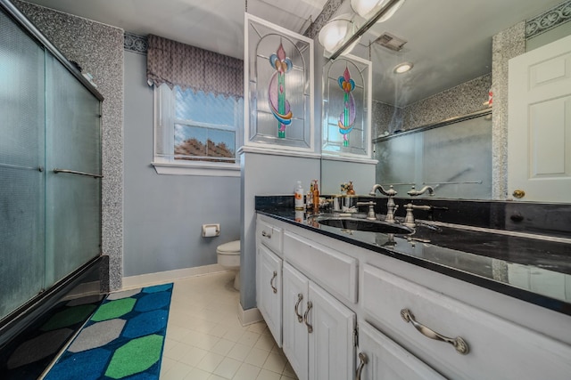 full bathroom featuring tile patterned floors, shower / bath combination with glass door, vanity, and toilet