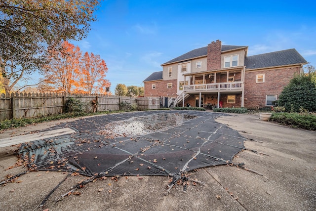 view of pool with a sunroom and a patio