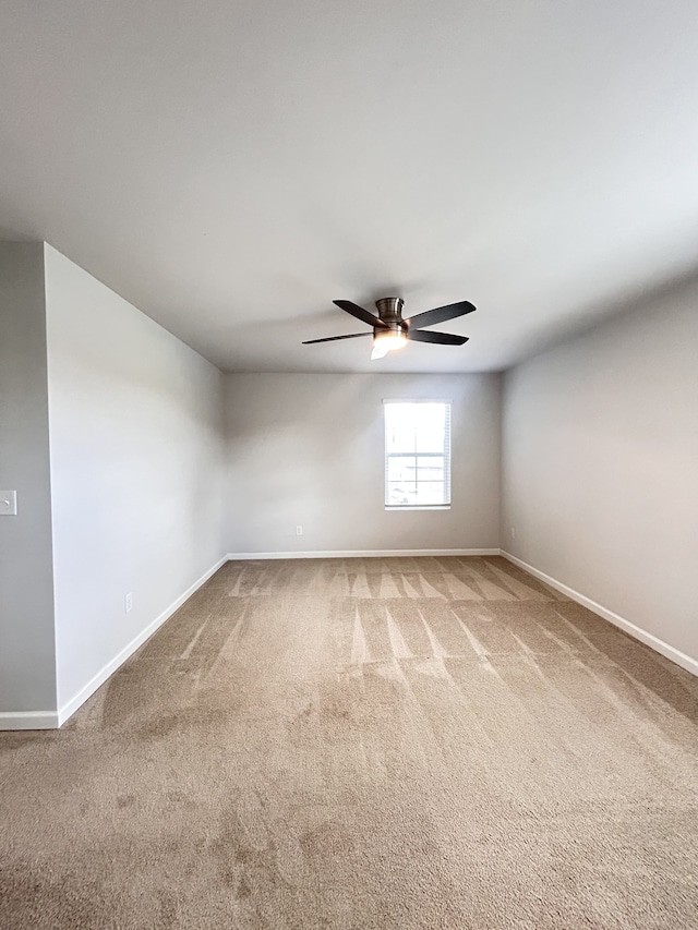 empty room with ceiling fan and carpet floors