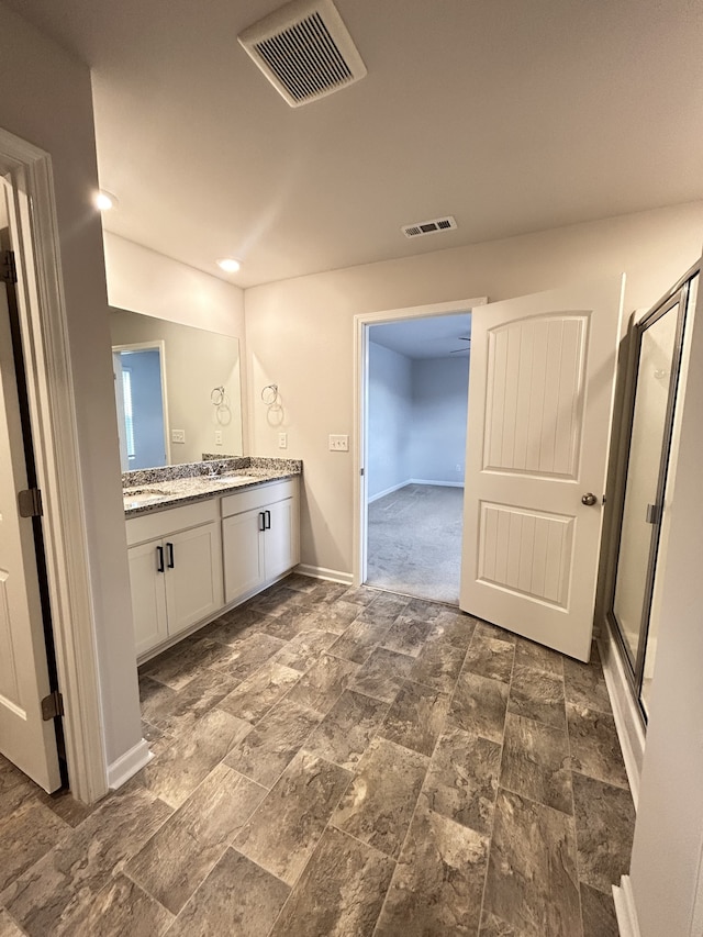 bathroom featuring vanity and an enclosed shower