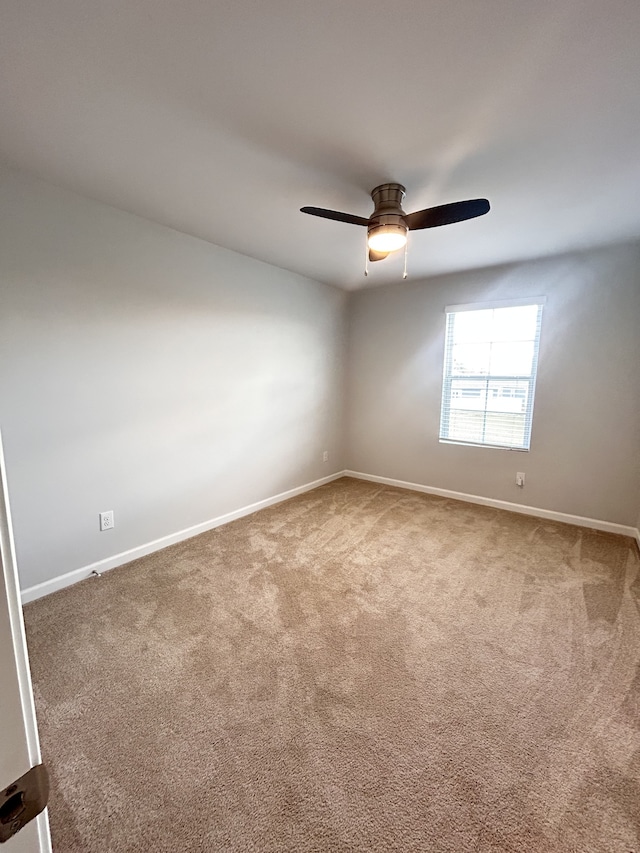 empty room featuring ceiling fan and carpet floors