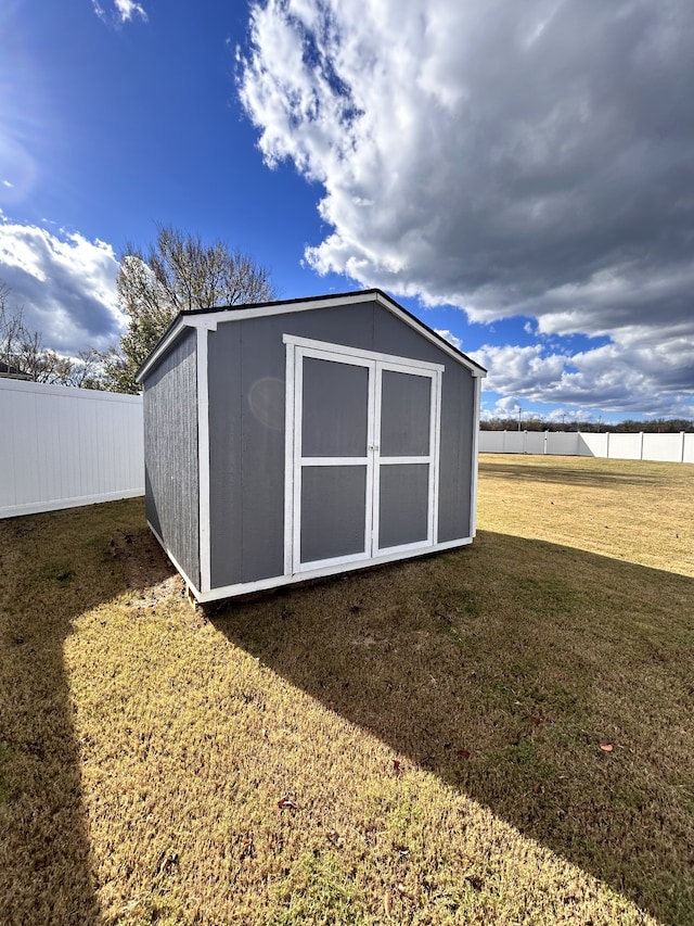 view of outbuilding featuring a lawn