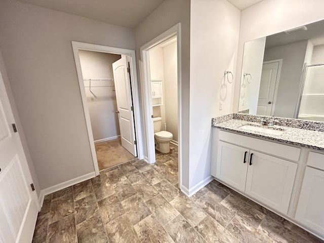 bathroom with vanity, toilet, and an enclosed shower