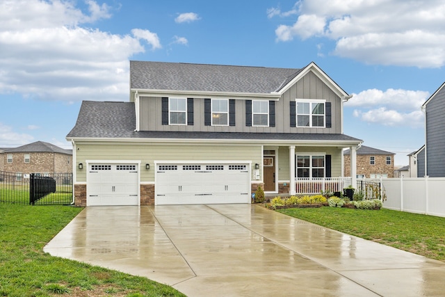 craftsman inspired home with covered porch, a garage, and a front yard