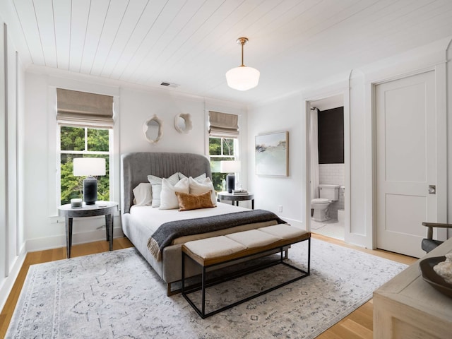 bedroom featuring wooden ceiling, ensuite bathroom, wood-type flooring, and multiple windows