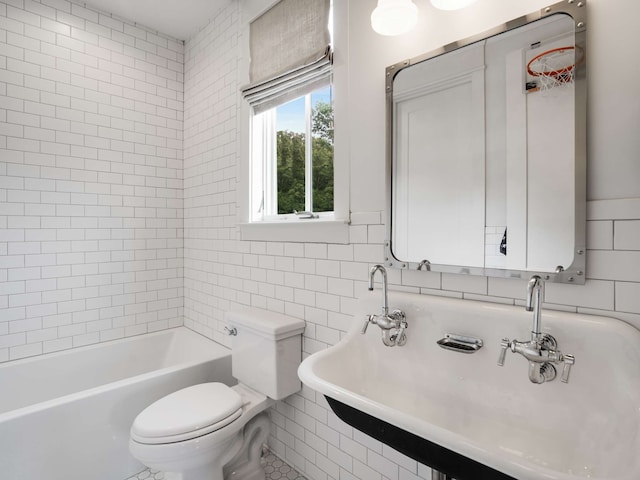 bathroom featuring tile patterned floors, sink, toilet, tile walls, and a tub