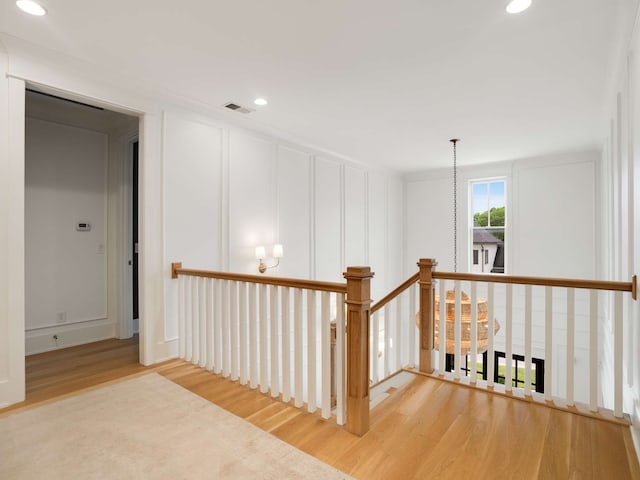 hall with hardwood / wood-style flooring