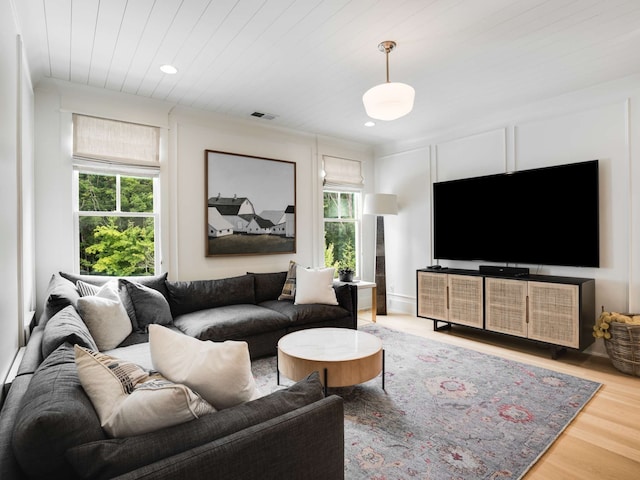 living room featuring plenty of natural light, wood-type flooring, and wood ceiling