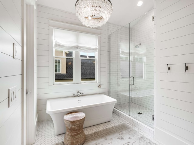 bathroom featuring a chandelier, shower with separate bathtub, tile patterned floors, and wood walls