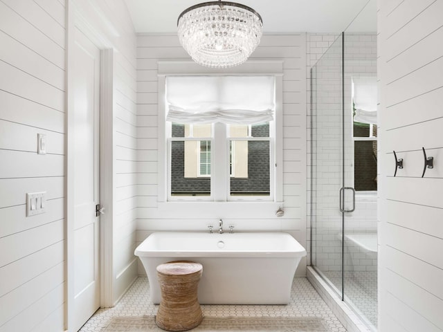 bathroom featuring tile patterned flooring, shower with separate bathtub, an inviting chandelier, and wood walls