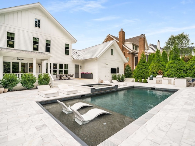 view of pool featuring an in ground hot tub, a patio, and ceiling fan