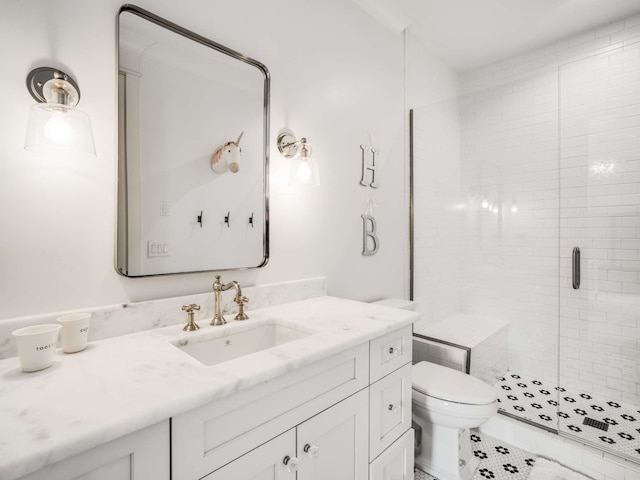 bathroom featuring a shower with door, vanity, and toilet