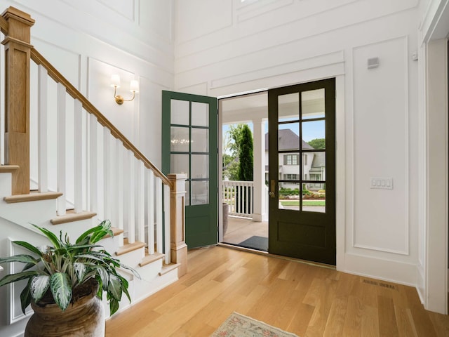 entrance foyer featuring hardwood / wood-style flooring and a high ceiling