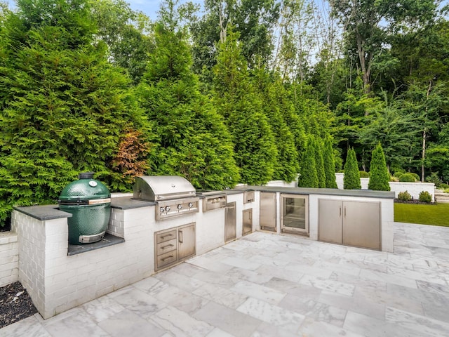 view of patio / terrace with an outdoor kitchen, a grill, and wine cooler