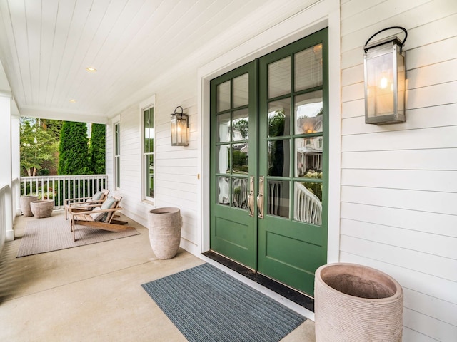 entrance to property with french doors and a porch