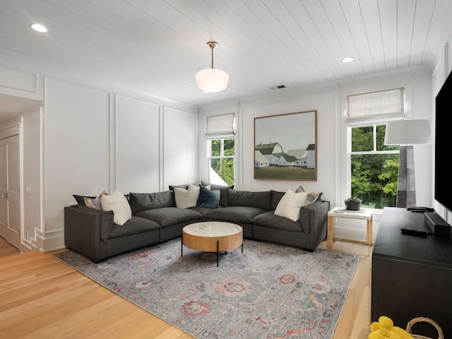 living room with a wealth of natural light, hardwood / wood-style floors, and wood ceiling