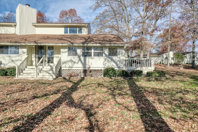 rear view of house with a yard