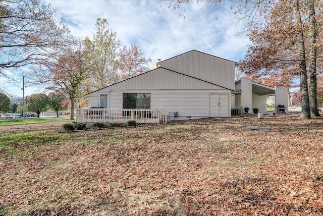 view of side of home with a deck and central AC unit