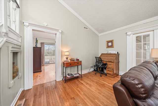 office with lofted ceiling, a textured ceiling, light hardwood / wood-style floors, and crown molding