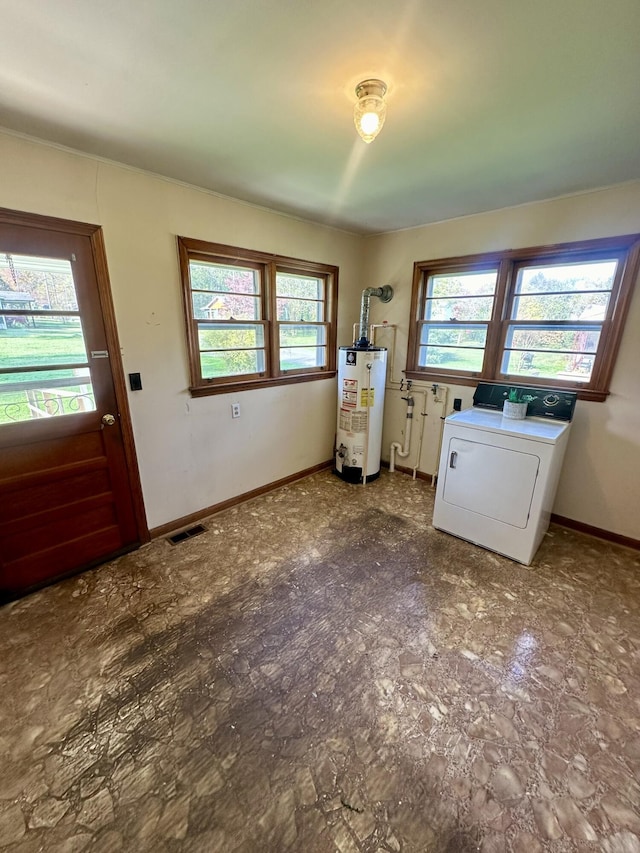 clothes washing area with independent washer and dryer, gas water heater, and a wealth of natural light