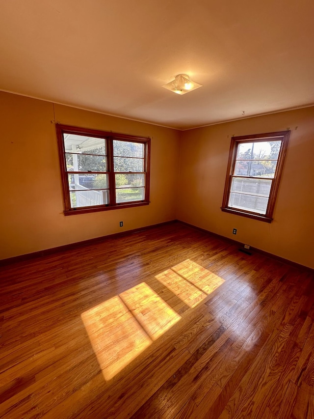 spare room with hardwood / wood-style floors