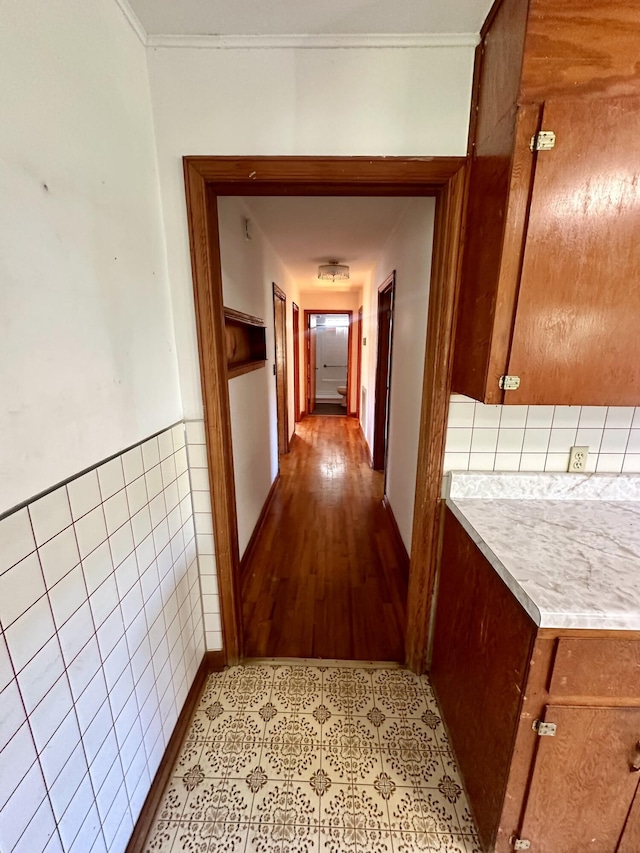 hall featuring light wood-type flooring and crown molding