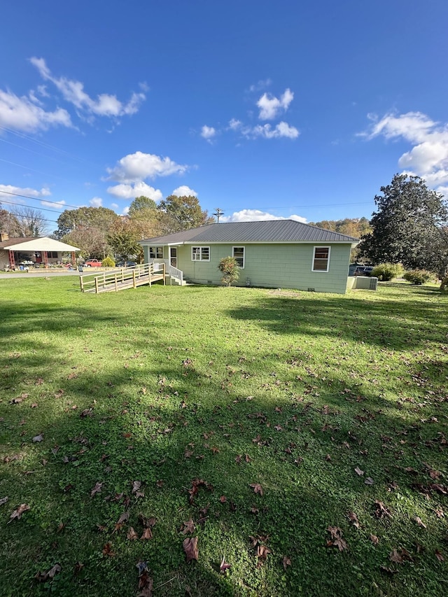 rear view of property with a yard