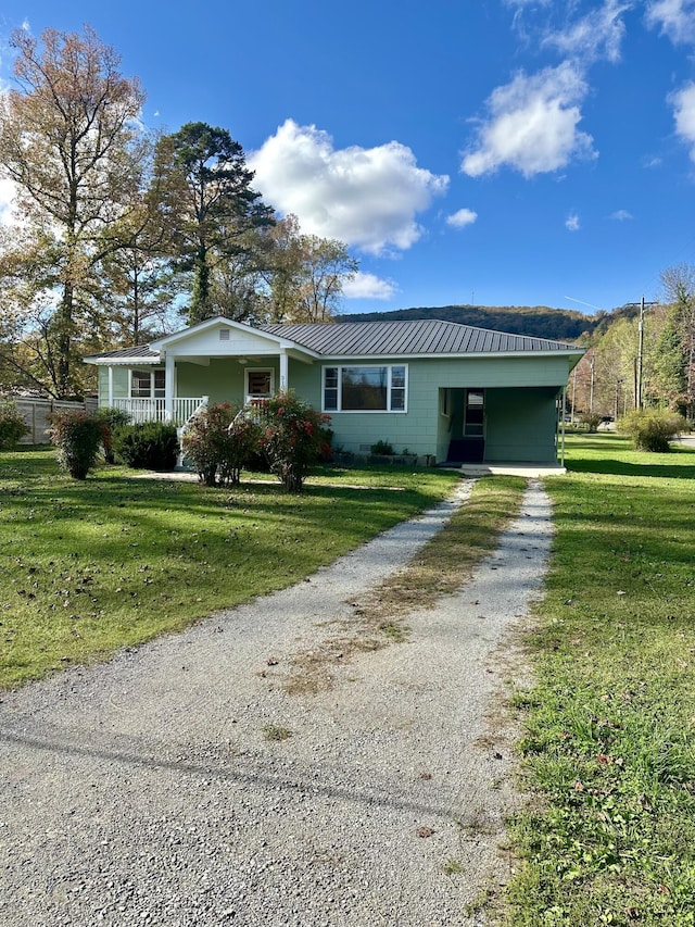 ranch-style home with a carport and a front lawn